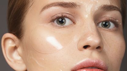 How to get rid of dark circles, Woman with skin care products on her face: eye patches and moisturizing gel mask