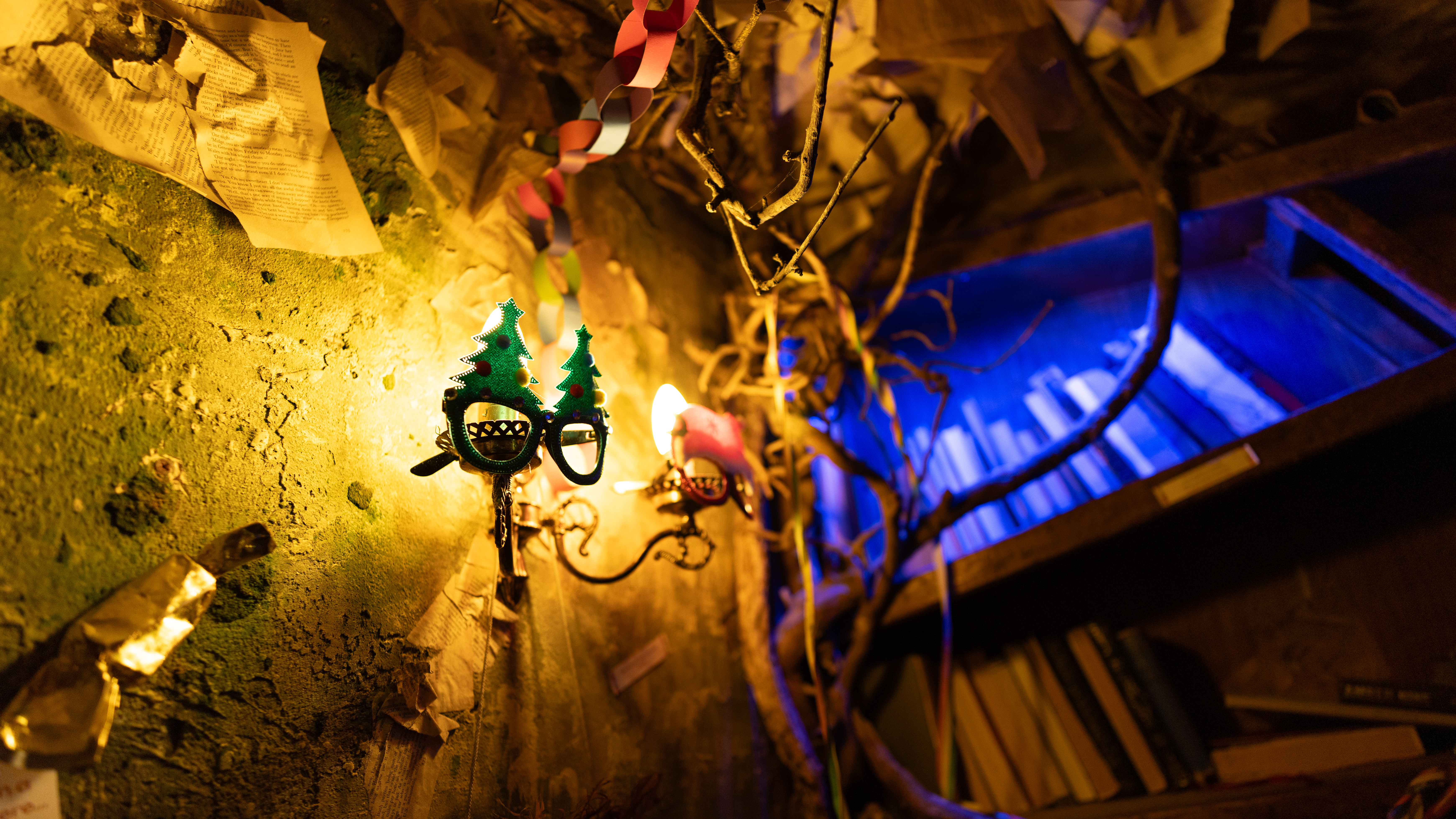 Scene from an indoor theme park, where various objects are arranged in a post-industrial scene with low light