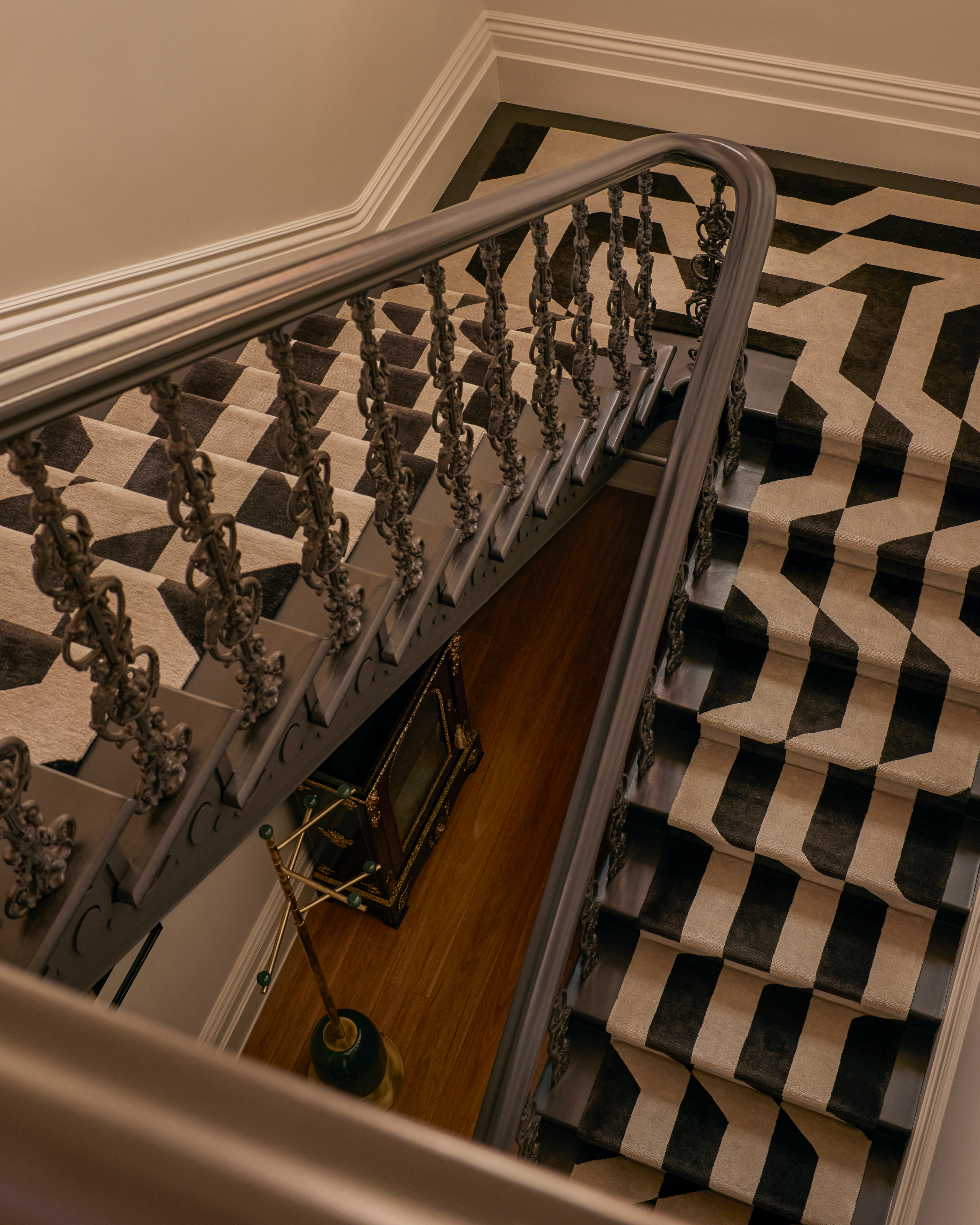 Staircase with black and white striped runner