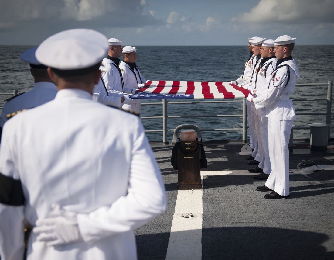 U.S. Navy Lieutenant Commander Paul Nagy, USS Philippine Sea, and Carol Armstrong, wife of Neil Armstrong, commit the cremated remains of Neil Armstrong to sea during a burial at sea service held onboard the USS Philippine Sea (CG 58), Friday, Sept. 14, 2