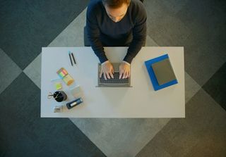 Overhead view of a man using an Intel laptop at a desk