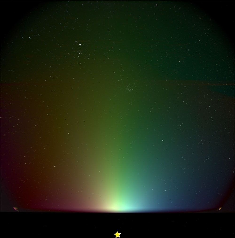 a colorful gradient of light seen against a starry background