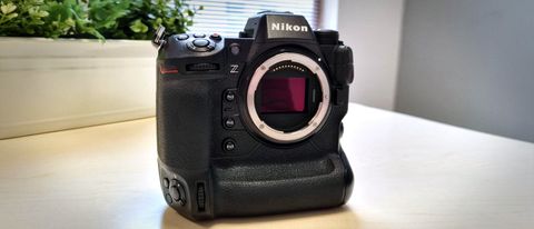 Nikon Z9 sitting on a wooden table in front of a window