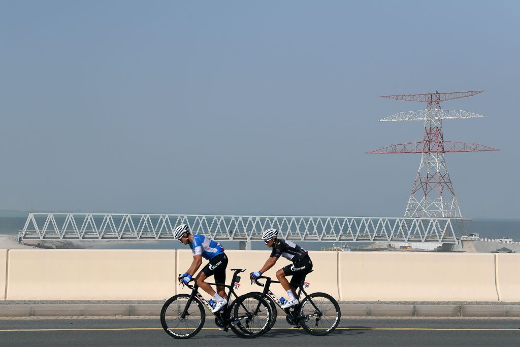 ABU DHABI UNITED ARAB EMIRATES FEBRUARY 21 LR Pavel Kochetkov of Russia and Dmitrii Strakhov of Russia and Team Gazprom Rusvelo most aggressive jersey compete in the breakaway during the 4th UAE Tour 2022 Stage 2 a 176km stage from Hudayriyat Island to Abu Dhabi Breakwater UAETour WorldTour on February 21 2022 in Abu Dhabi United Arab Emirates Photo by Tim de WaeleGetty Images
