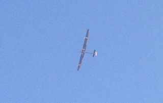 The Solar Impulse plane flies over Palo Alto, Calif., in this photo taken by a spectator using his iPhone.