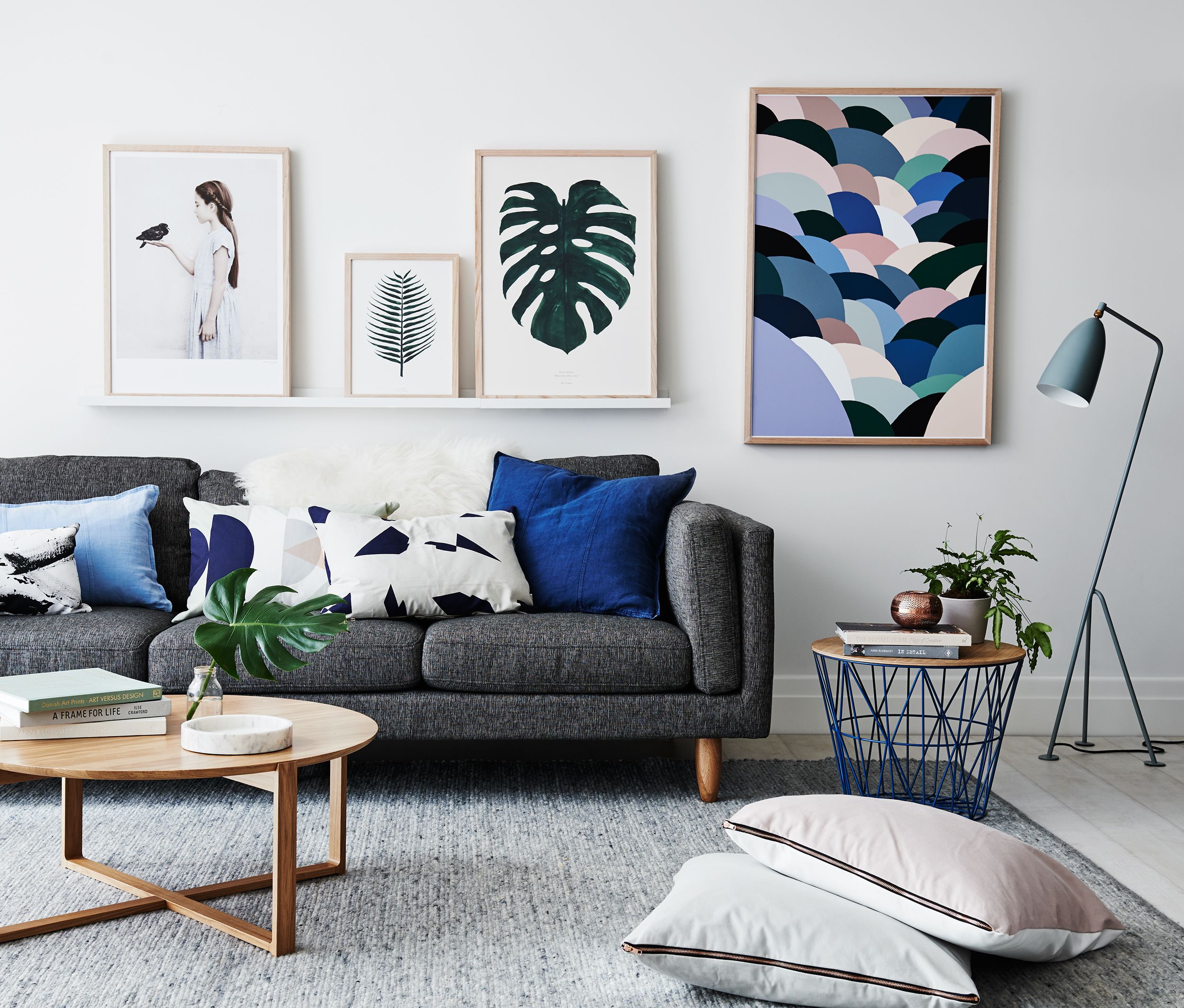 Grey living room with dark grey sofa, grey rug and bright gallery wall
