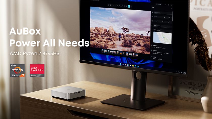 The Chuwi Aubox 8745 mini PC pictured on a home office desk with monitor.