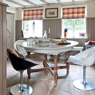 dinging room with two windows and circle dining table