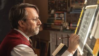 David Mitchell in glasses compiling a puzzle as John Taylor in Ludwig