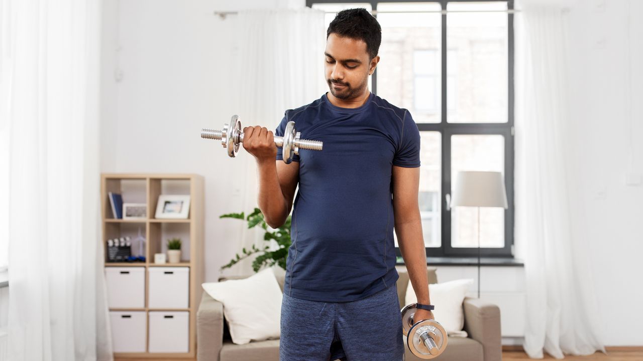 Man lifting dumbbells during home workout