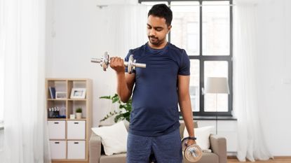 Man lifting dumbbells during home workout