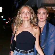 Nicole Richie wears a strapless top and jeans.