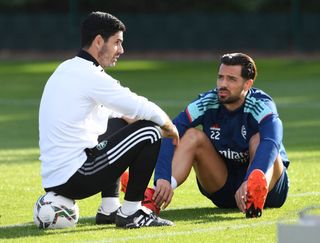 Mikel Arteta the Manager of Arsenal chats to Pablo Mari during the Arsenal 1st team training session at Arsenal Training Centre on August 24, 2021 in London, England.