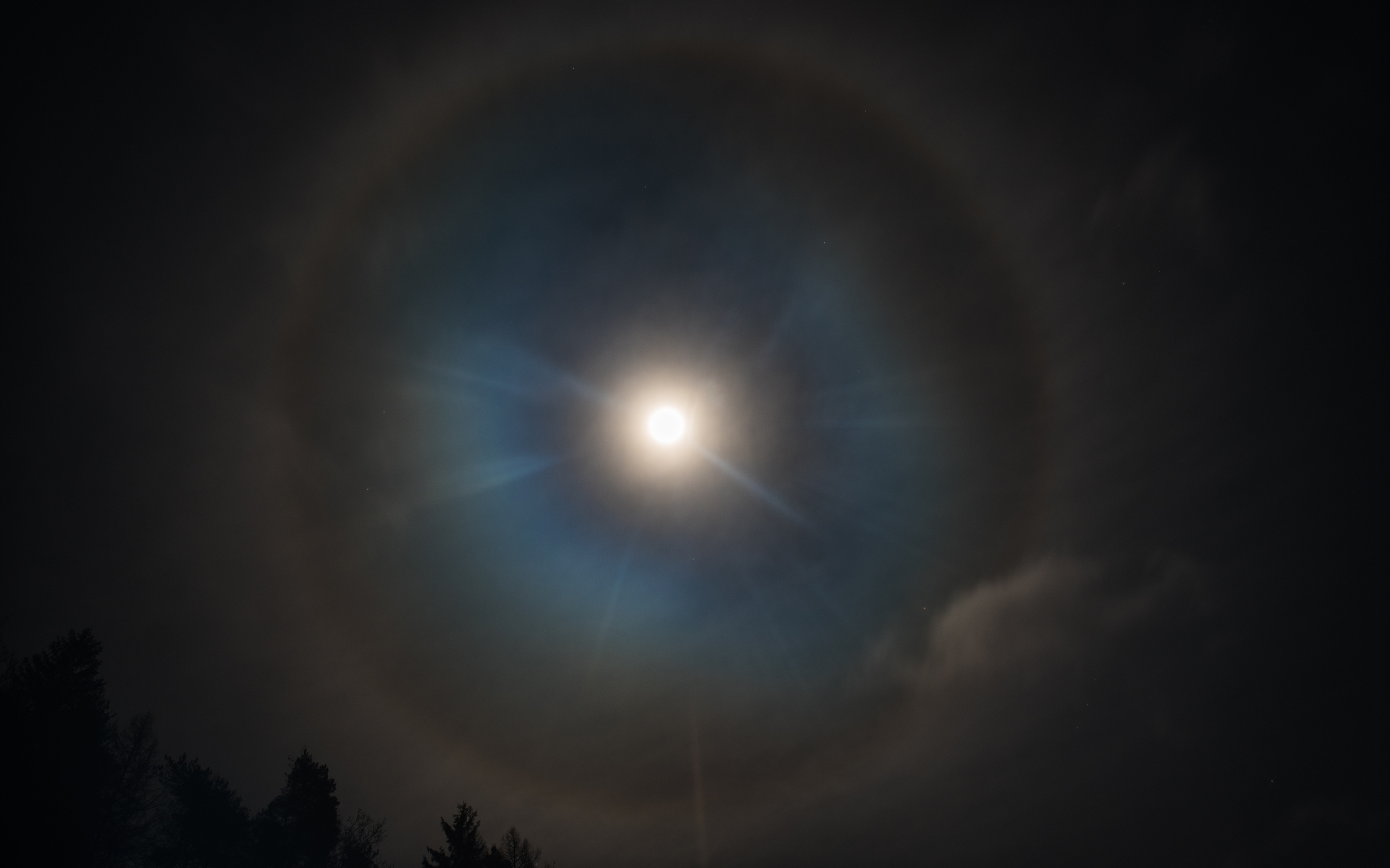 A ring of light forms a halo around the moon.