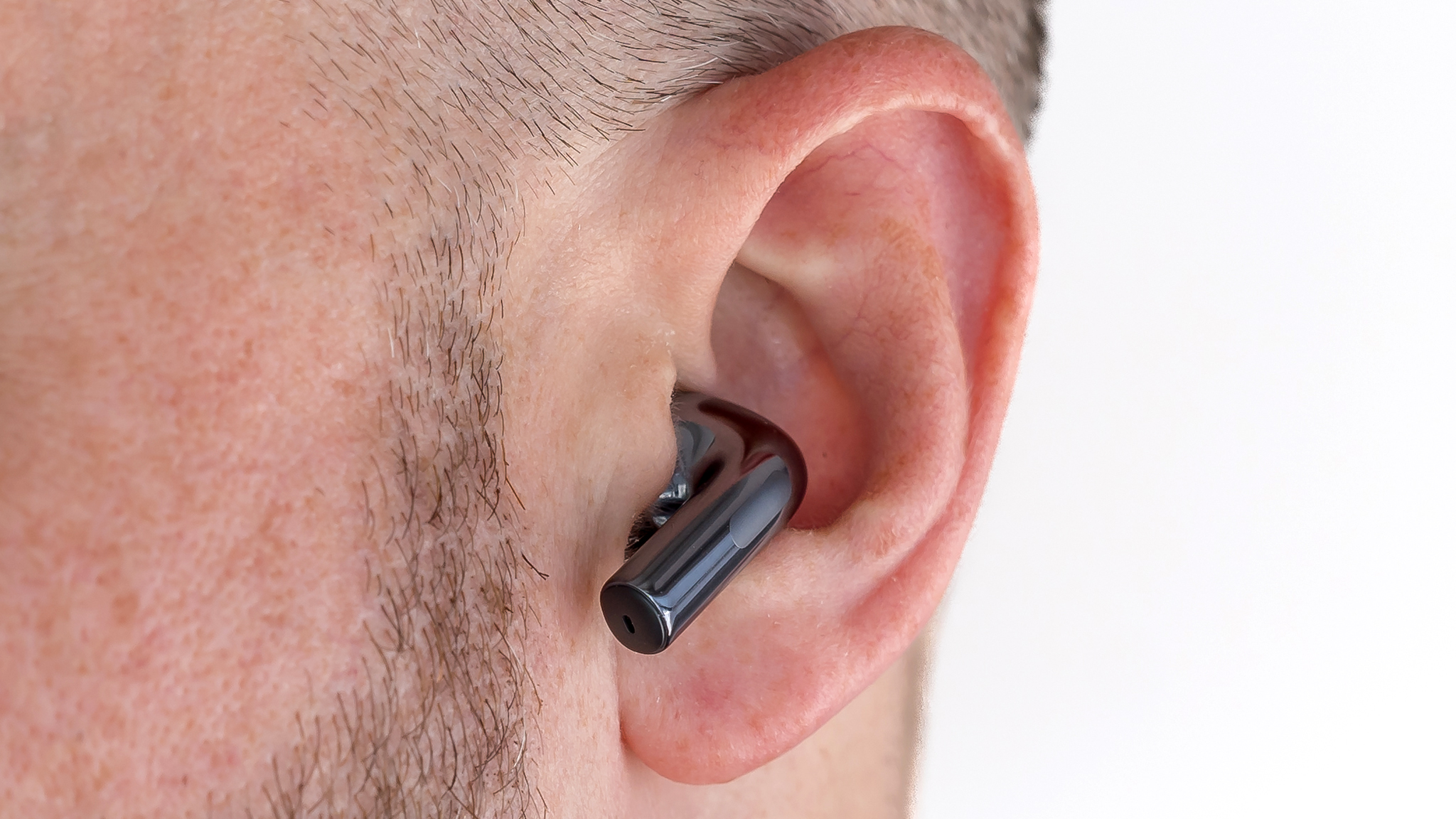 Close-up view of OnePlus Buds 3 earbud in ear.