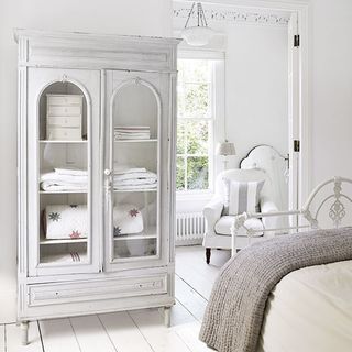 bedroom with white wall and wardrobe