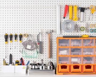 peg board with tools and storage drawers