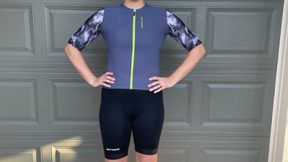 Woman cyclist wearing Attaquer jersey and bib shorts