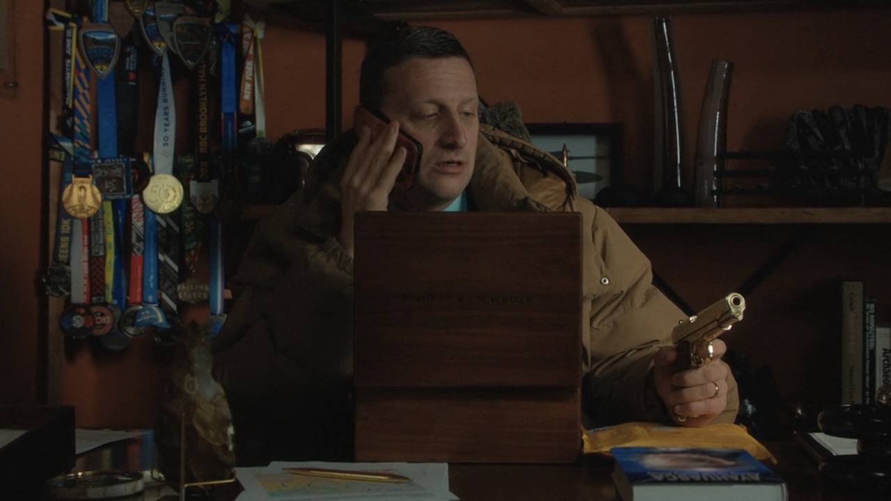 Craig on phone holding golden pistol in Friendship