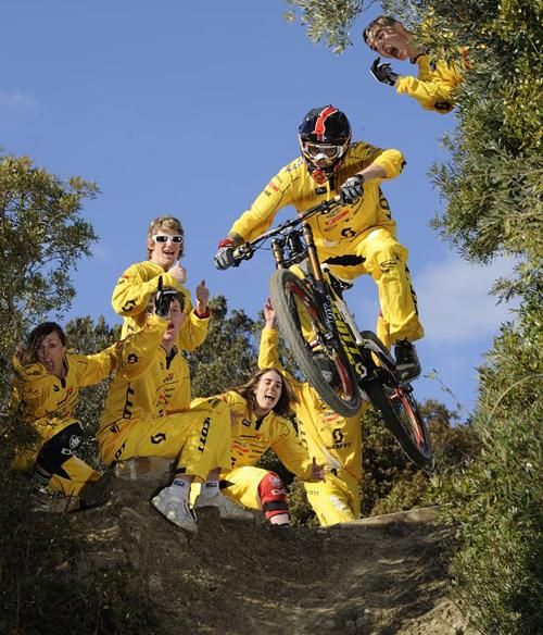 Scott11 riders cheer on their teammate during a downhill run