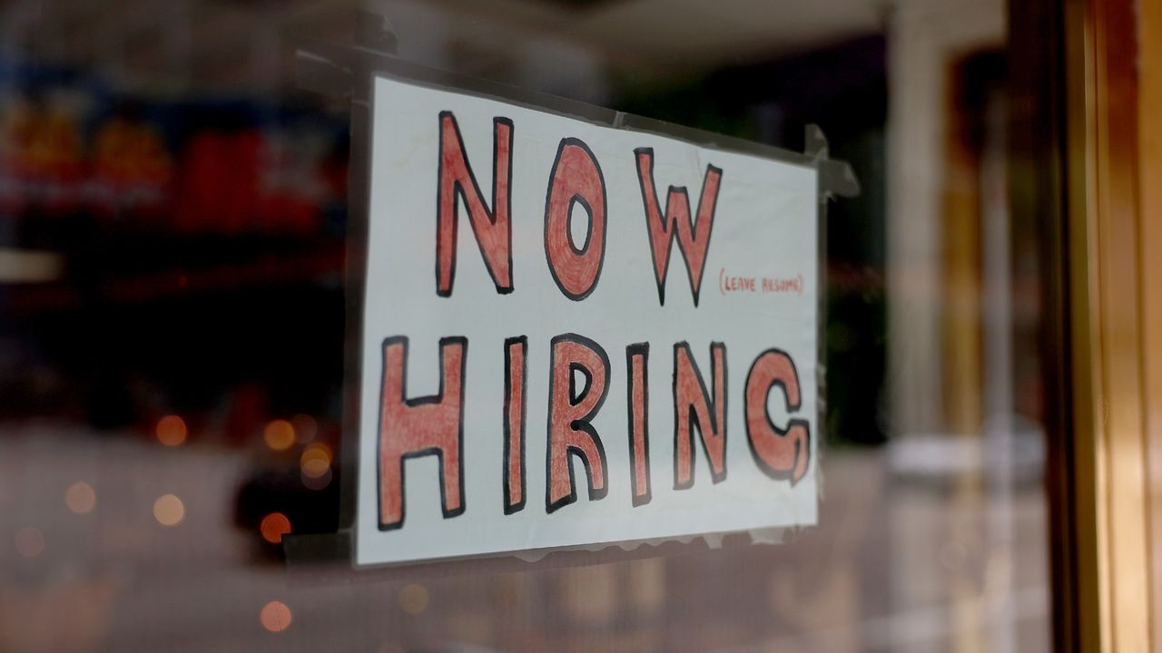 A &#039;now hiring&#039; sign is seen at a business in Miami, Florida.