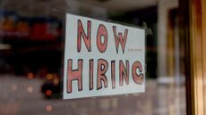 A 'now hiring' sign is seen at a business in Miami, Florida.