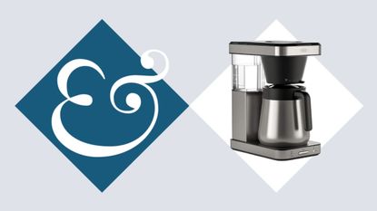 A stainless steel drip coffee maker on beside a blue diamond with an & sign in it.