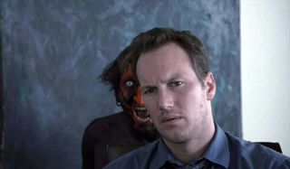Something creepy stands behind Patrick Wilson in Insidious.