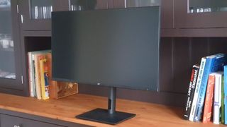 Monoprice monitor switched off on a wooden sideboard cabinet