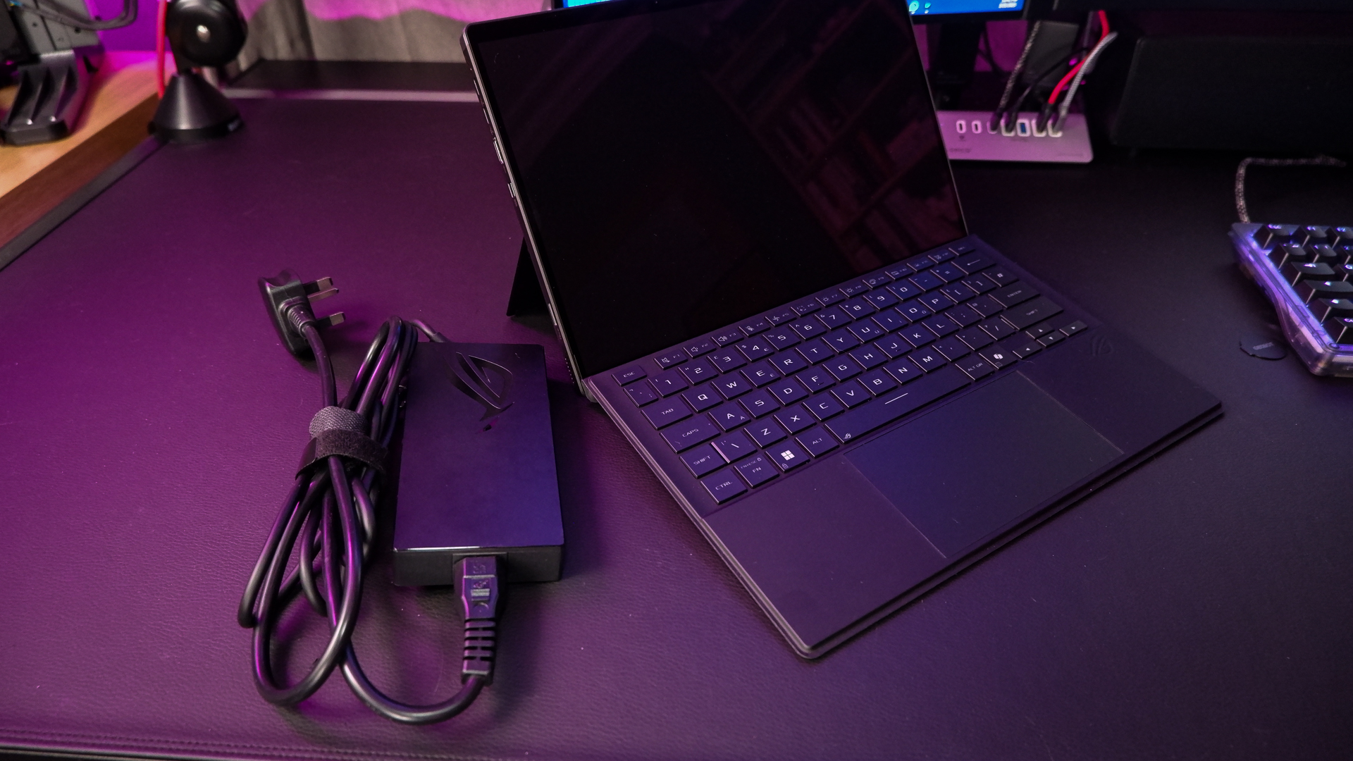 An ROG Flow Z13 (2025) set up on a desk with the detachable keyboard and charger.