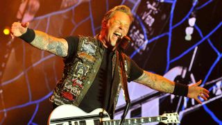 Metallica’s James Hetfield onstage with his arms spread wide