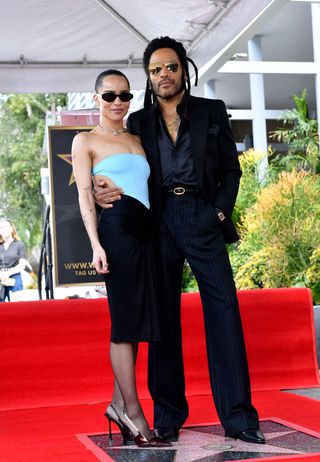 US musician Lenny Kravitz poses with his daughter actress Zoe Kravitz on his newly unveiled star during his Walk of Fame ceremony in Los Angeles, California, on March 12, 2024.