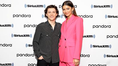 Zendaya and Tom Holland pose together on a red carpet