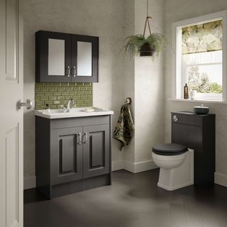 bathroom with dark brown fittings and green tiles
