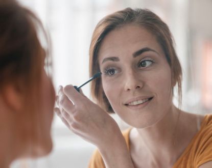 Woman applying mascara