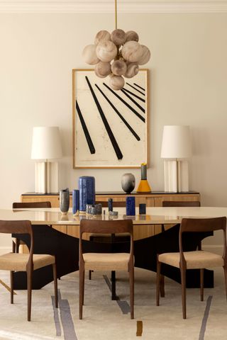 a dining room with symmetrical lamps