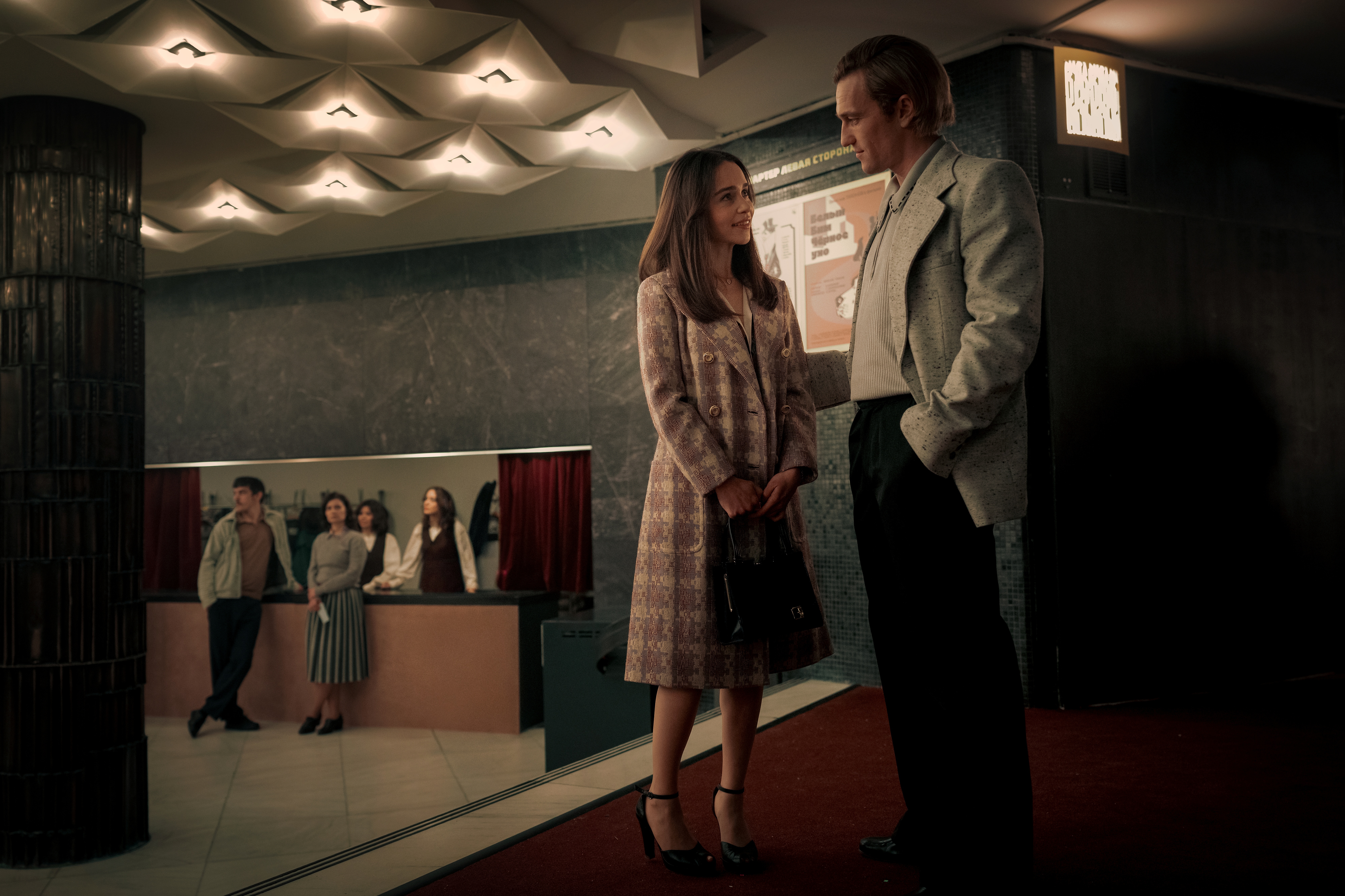 A series of film stills and photographs from a 1970s-inspired set featuring vibrantly decorated interiors with layered furniture and warm lighting, along with characters dressed in vintage clothing whether indoors or at parks, in cards, or at markets outdoors.