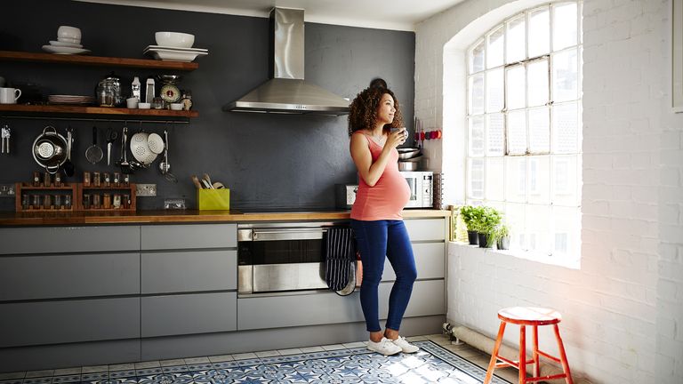 Pregnant woman in kitchen: cut your kitchen costs