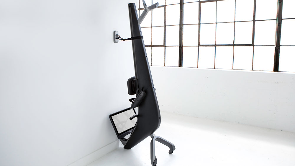 Hydrow rowing machine stored on end and attached to wall