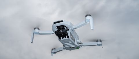 Potensic Atom drone in flight against overcast sky
