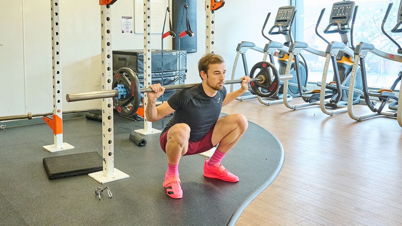 Andy Turner holding a squat as part of his 12 week strength training program for cyclists