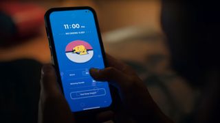 Man using Pokémon Sleep app in bed