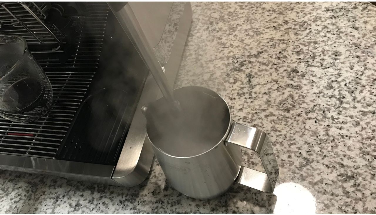 steaming milk with the De'Longhi La Specialista Maestro