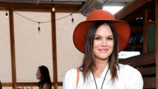 RACHEL BILSON WEARING A HAT AND WHITE TOP