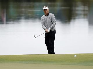 Bernhard Langer chipping the ball onto the green