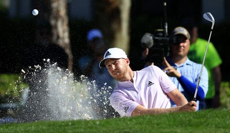 Berger hits a bunker shot