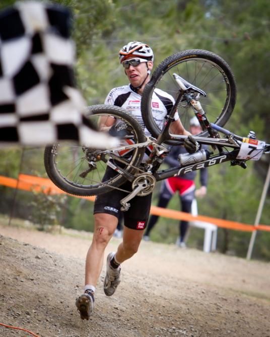 Swiss rider Thomas Litscher tries to run to the finish of Cyprus Sunshine Cup after a massive crash.