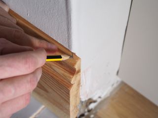 marking a skirting board mitre with a pencil