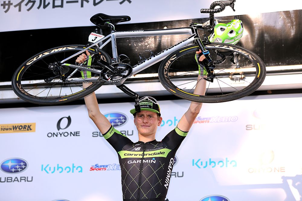 Matej Mohoric lifts his bike above his head