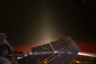 The outside of the International Space Station with the curve of the Earth in the background